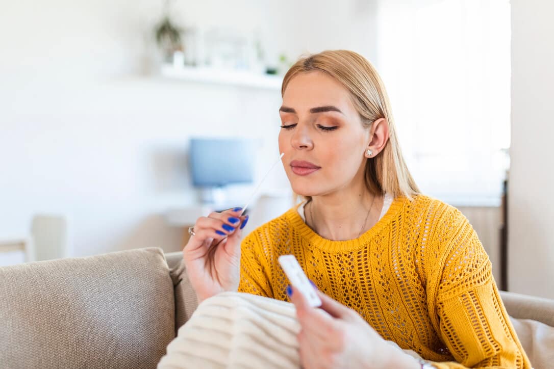 Woman taking an at home test for covid-19.