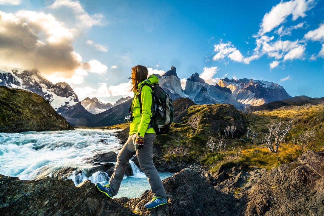 Woman hiking alone in a mountain landscape.