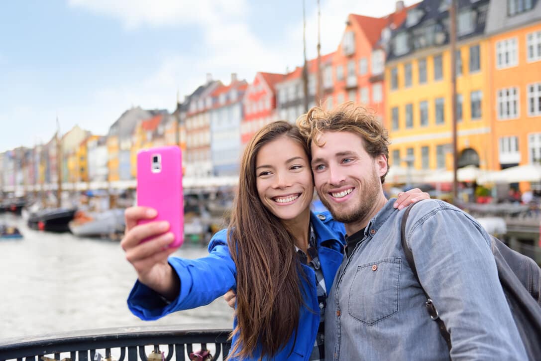 Pair of tourists in the old port of Nyhavn in Denmark.