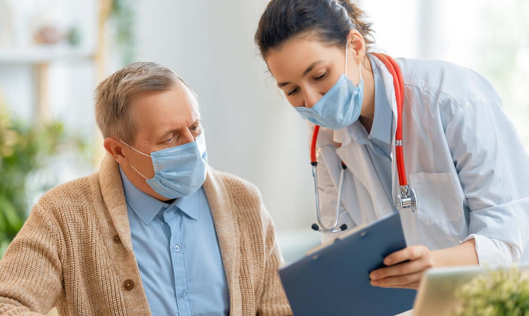 Female doctor explaining to an elderly pacient the New Covid-19 Variant, Omicron BA.2..