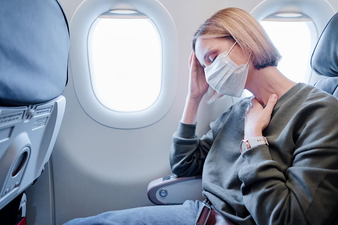 Woman getting sick while travelling by plane