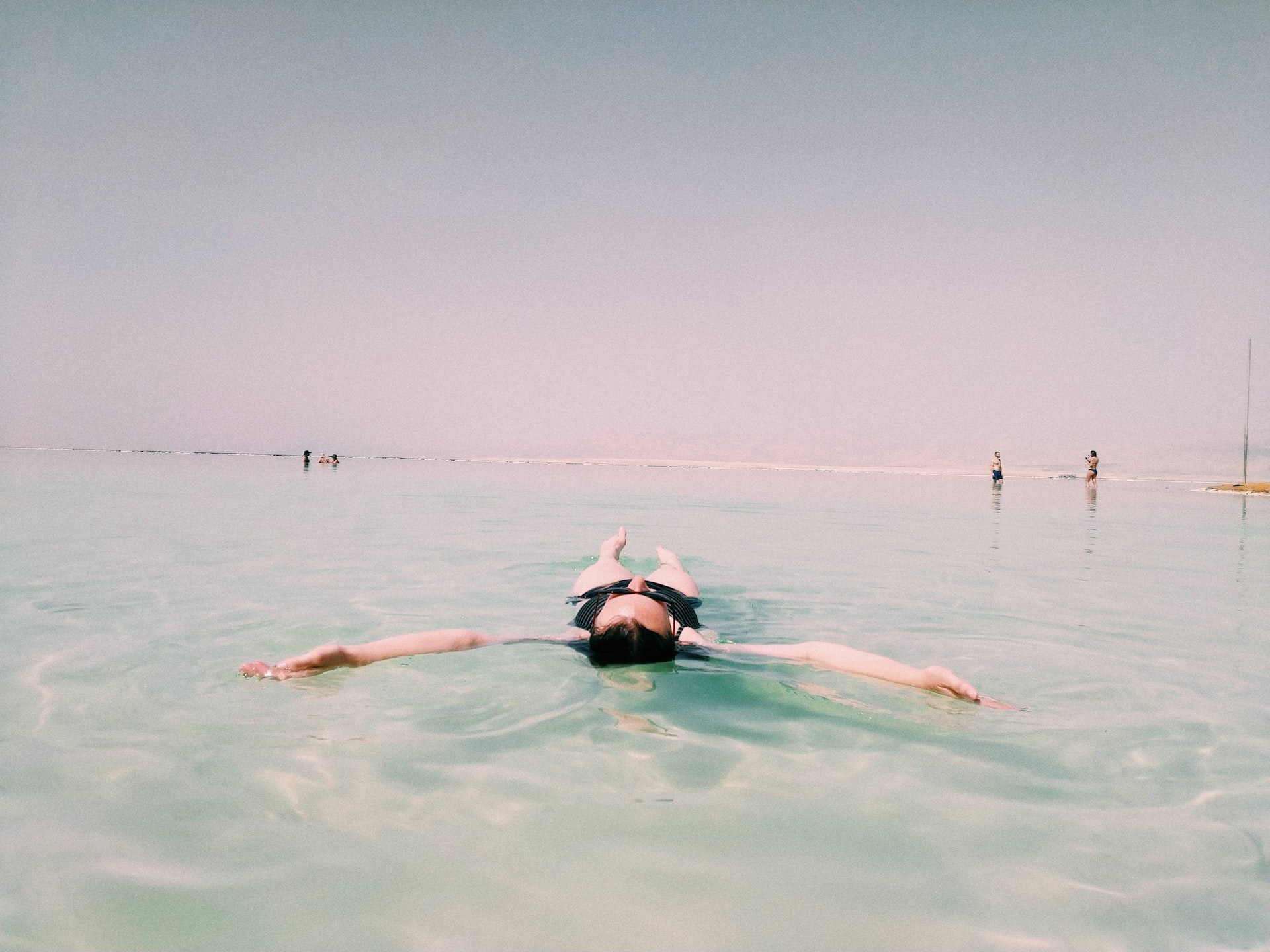 Young woman floating in relaxation in the dead sea.