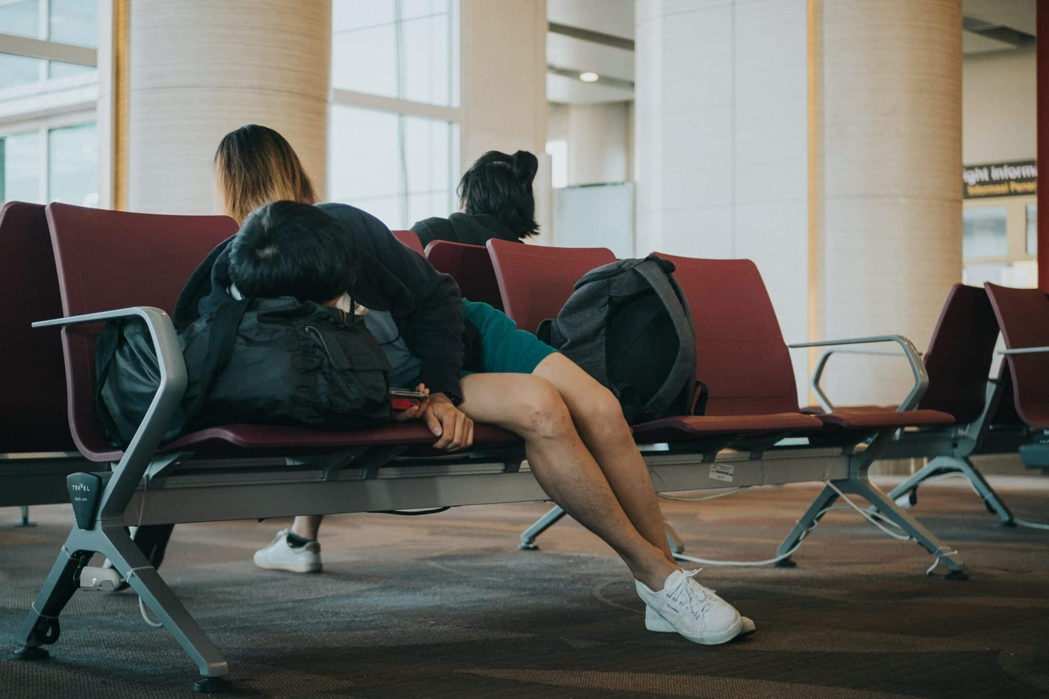 man sleeping in an airport